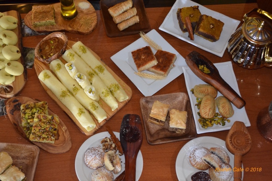 Knafeh Cafe menu spread with fresh Middle Eastern desserts
